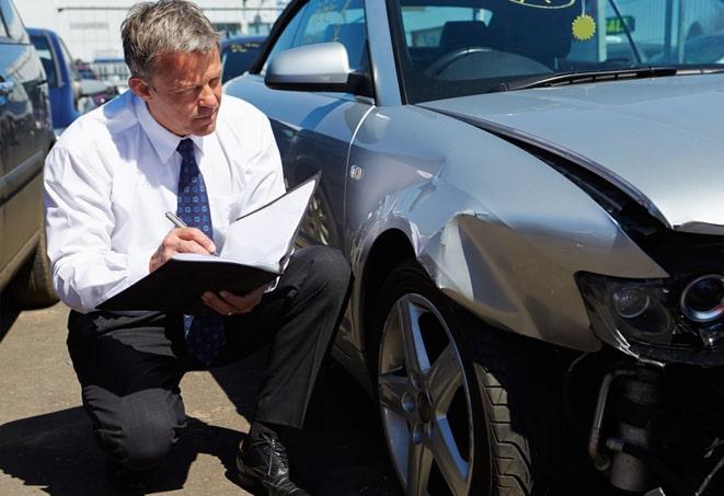 young woman filling out paperwork for car insurance